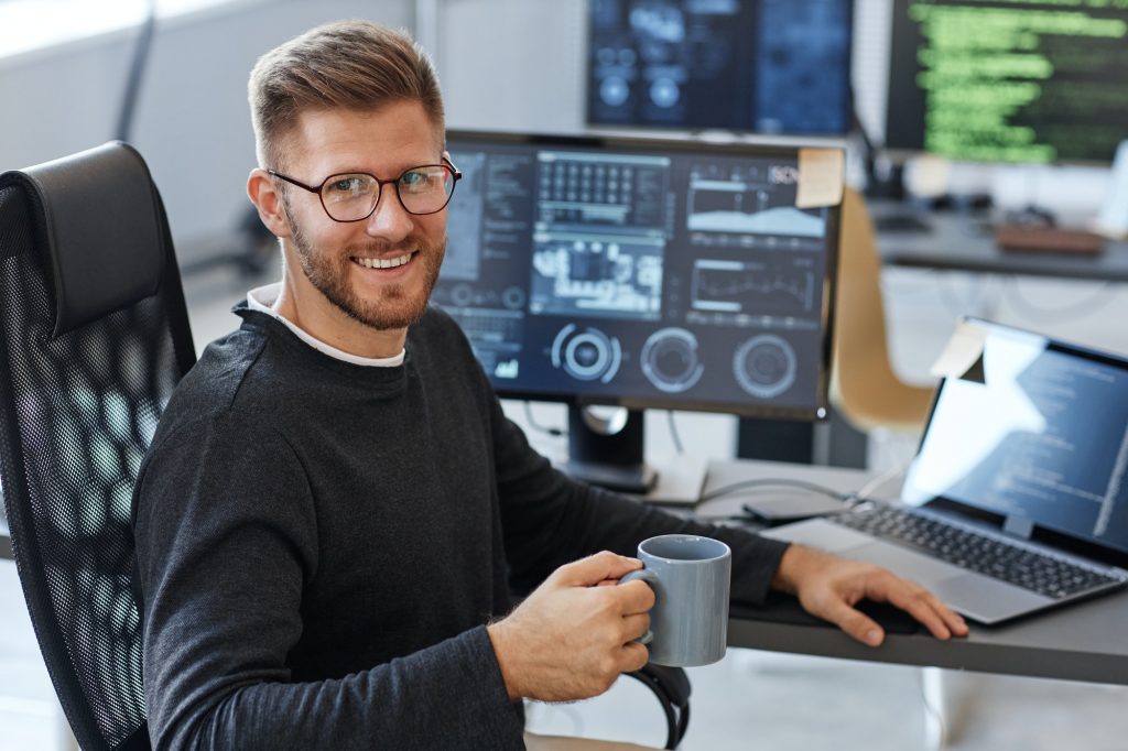 Smiling Computer Programmer at Workplace